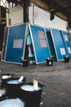 Ivos screen printing screens surrounded by numerous paint pots, ready for printing in a vibrant workshop setting.